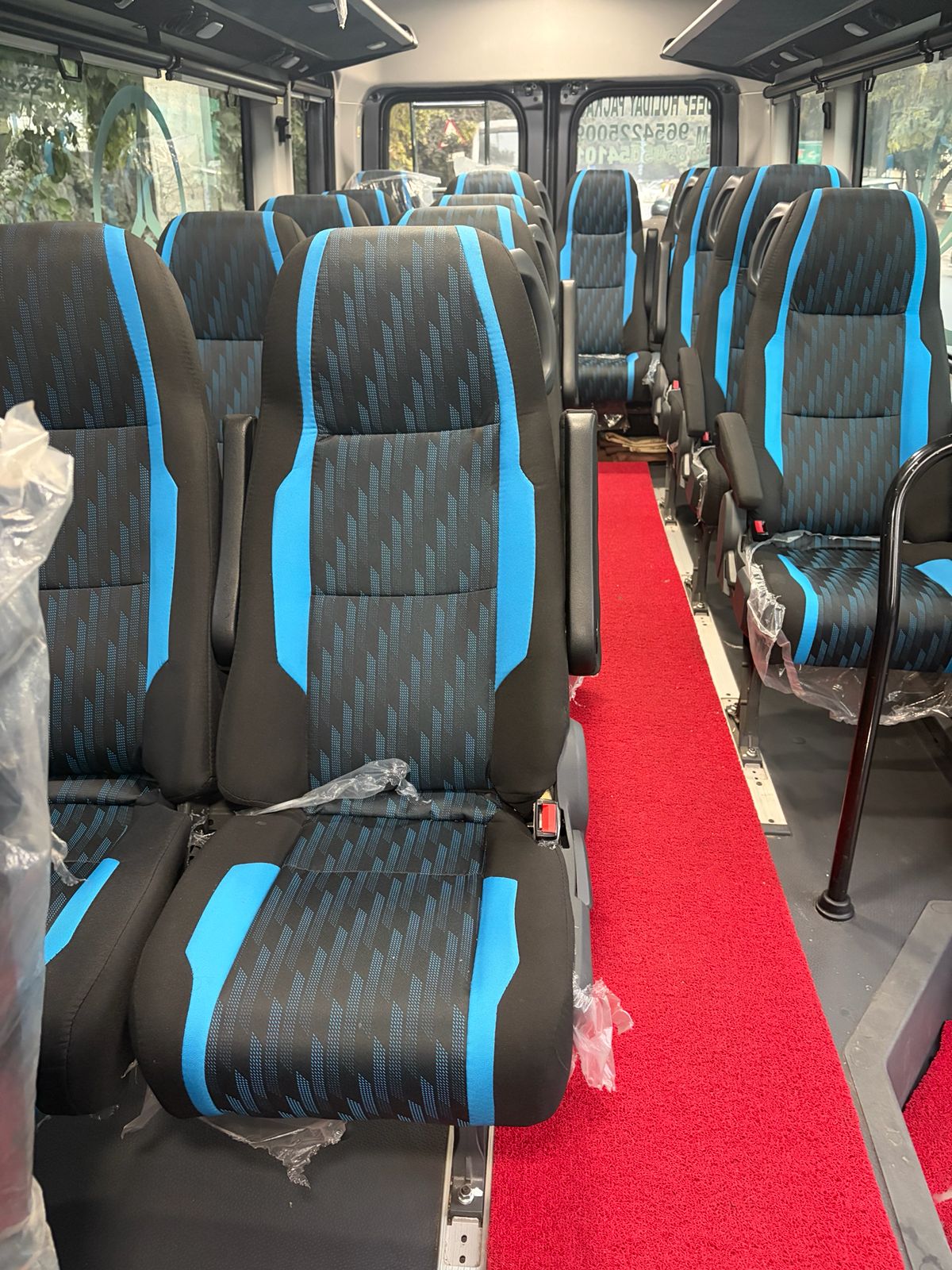 Blue and black seats inside the Force Urbania 17 seater